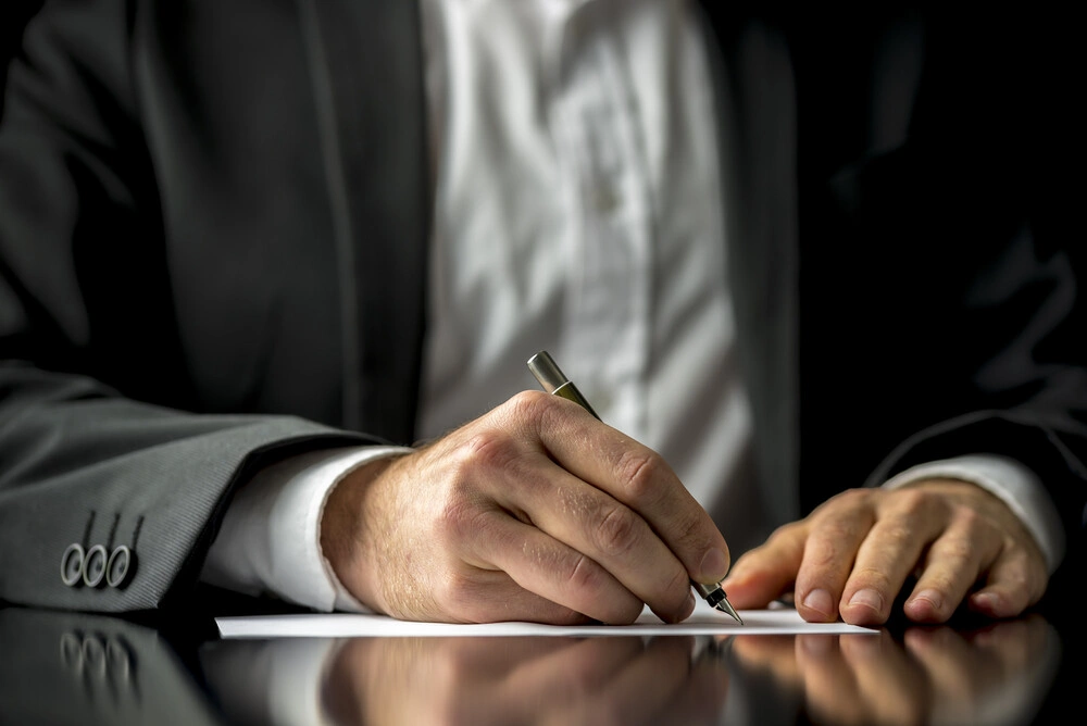 Man signing a document